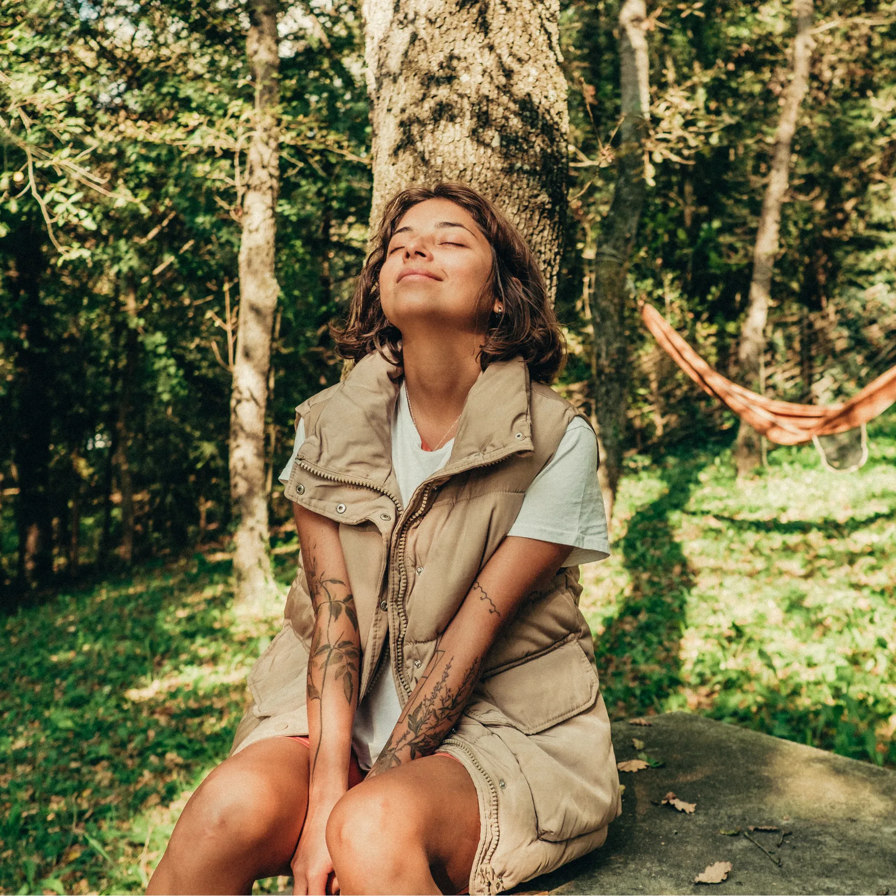 Woman sitting outdoors in sunlight