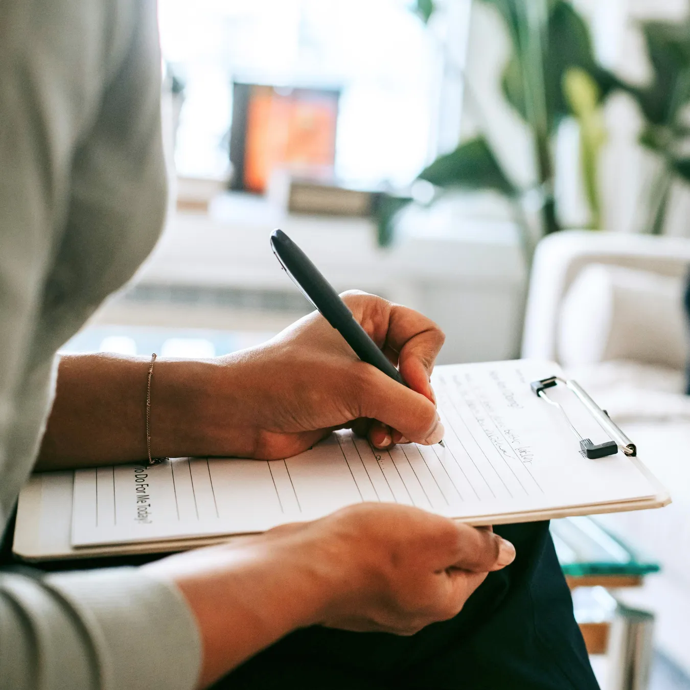 Woman writing on a clipboard