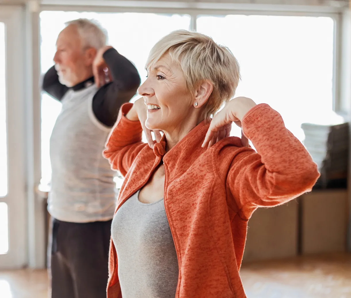 Older man and woman doing stretching exercises