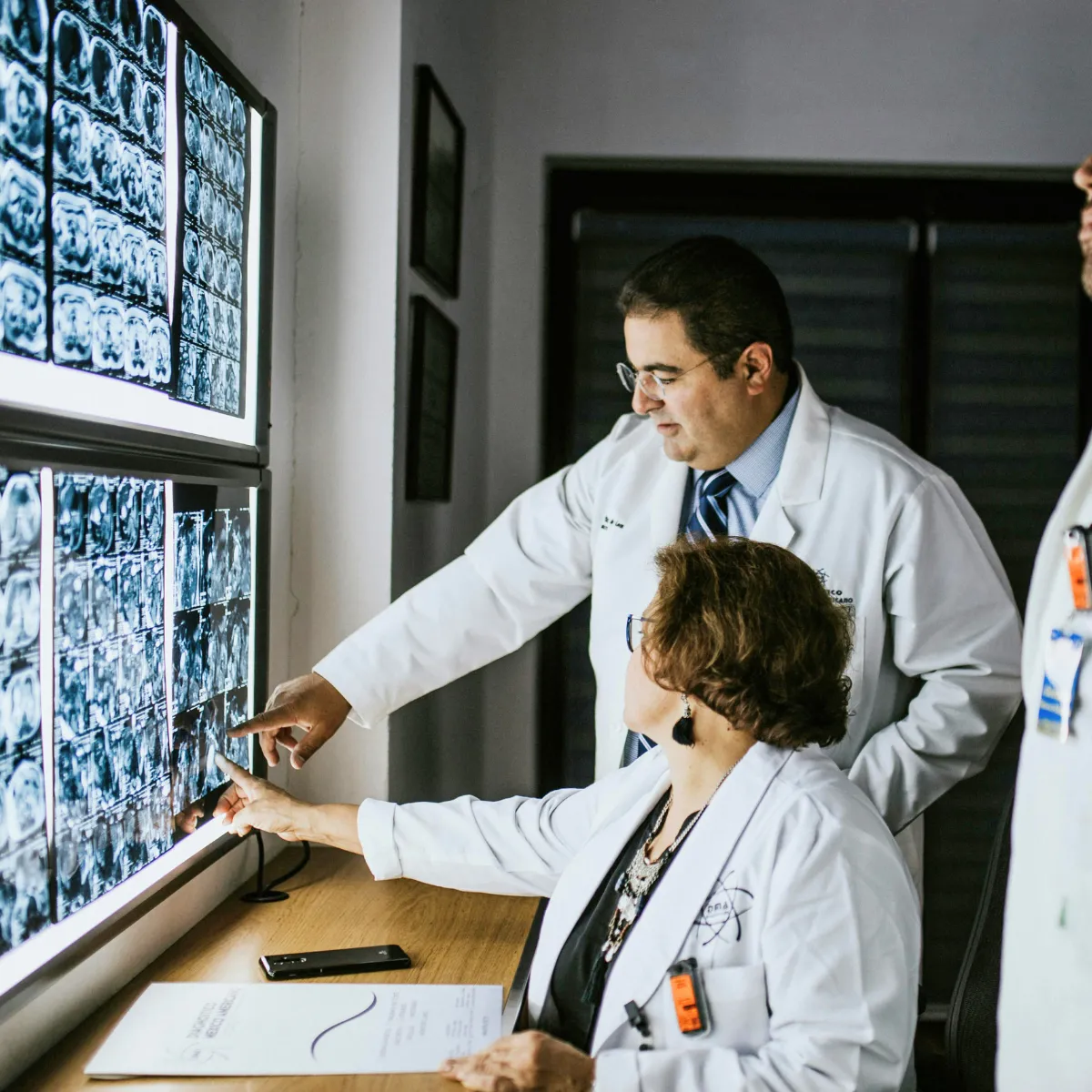 Physicians pointing at a screen