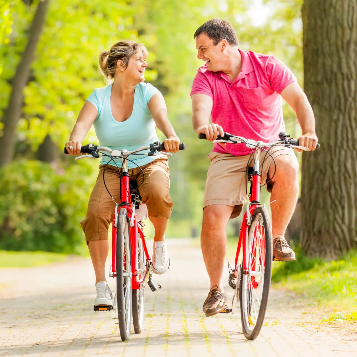 A couple riding bikes together outdoors
