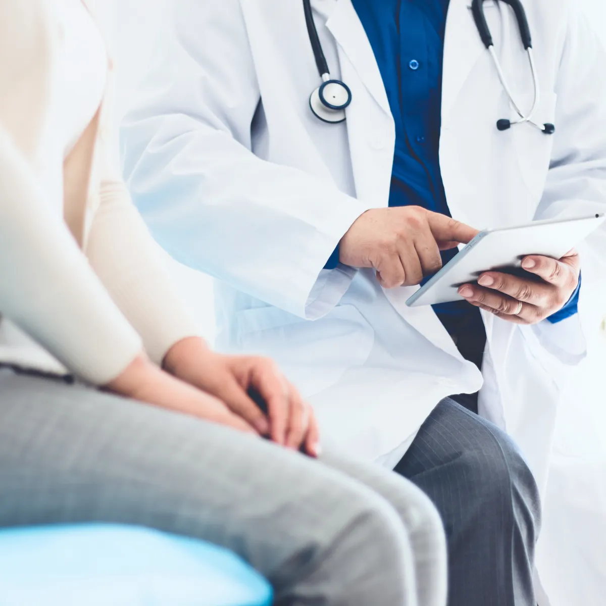 Doctor showing a patient something on a notepad