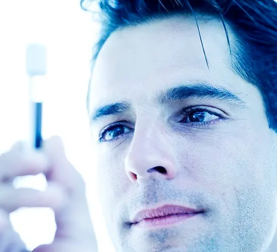 Doctor looking at a test tube